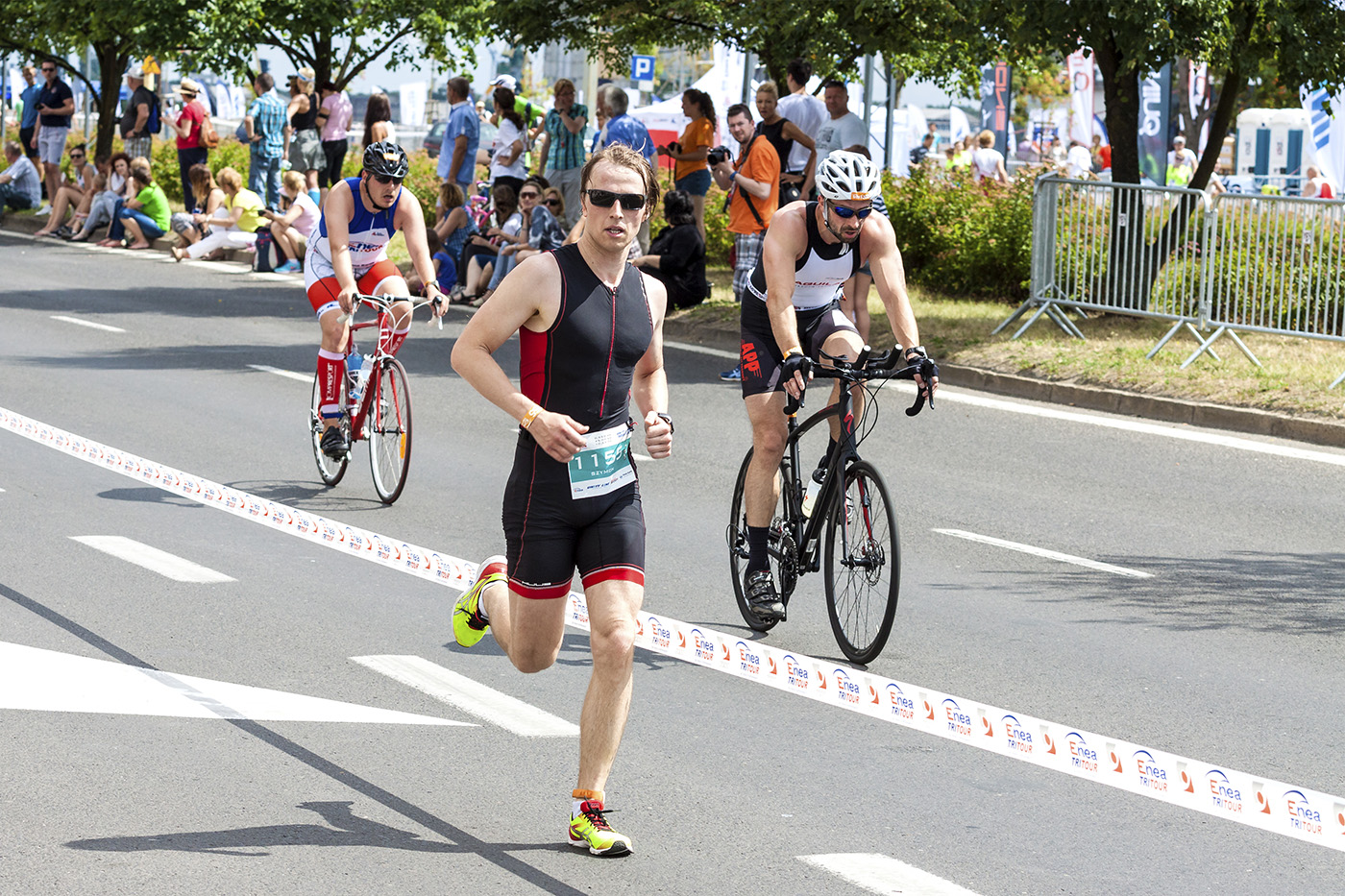 SZCZECIN, POLAND - JULY 06, 2014: Runner and cyclists during fir