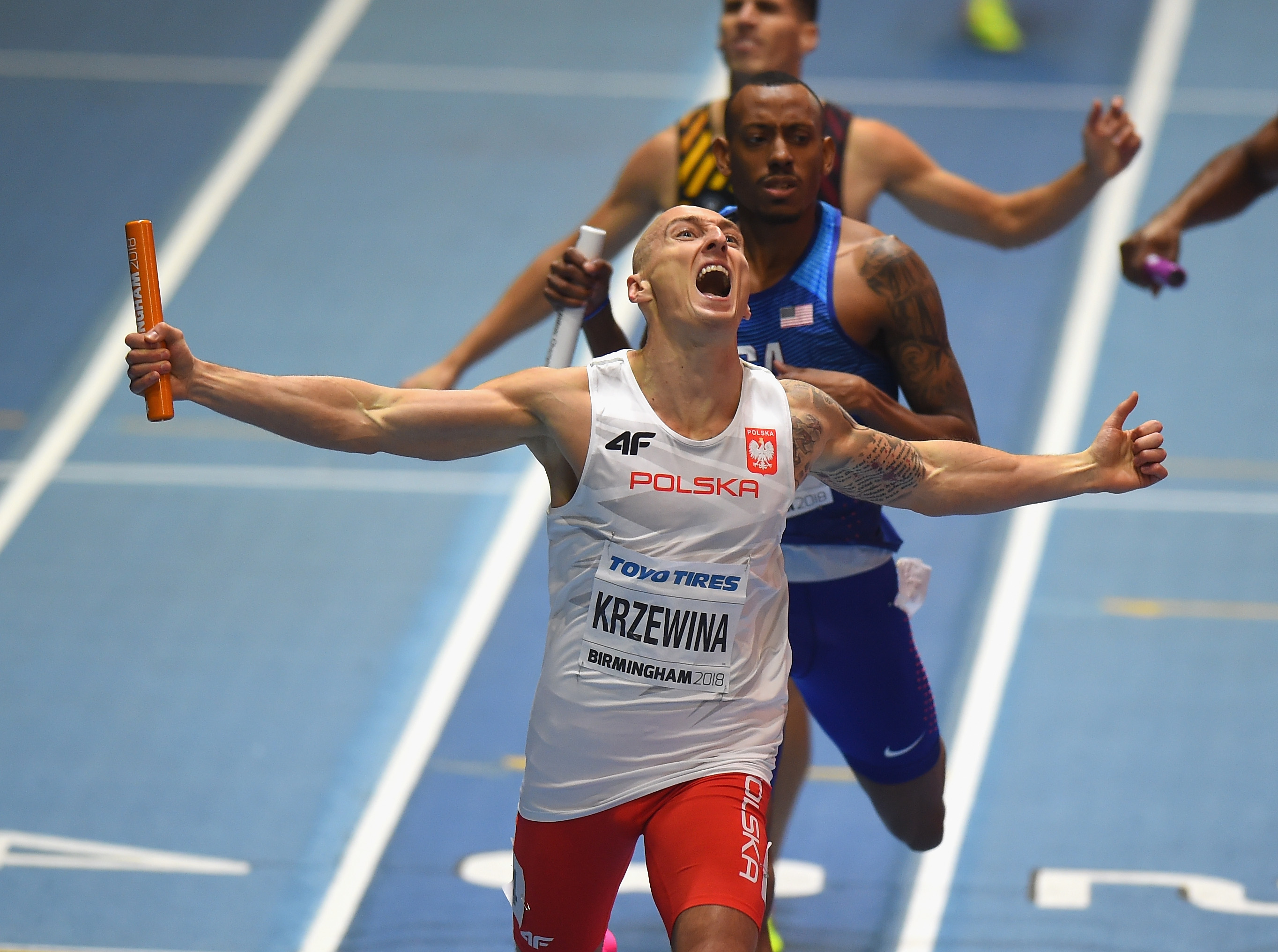 BIRMINGHAM, ENGLAND - MARCH 04: Jakub Krzewina of Poland wins the Men's 4 x 400m Relay Final from Vernon Norwood of the United States during Day Four of the IAAF World Indoor Championships at Arena Birmingham on March 4, 2018 in Birmingham, England. (Photo by Tony Marshall/Getty Images)
