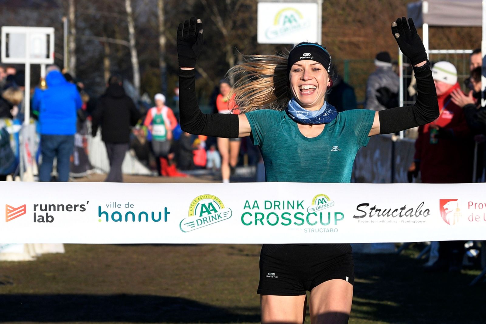 Poland's Anna Gosk celebrates as she crosses the finish line to win the women's race at the fourth stage of the Structabo CrossCup cross country running competition in Hannut on January 20, 2019. (Photo by YORICK JANSENS / BELGA / AFP) / Belgium OUT